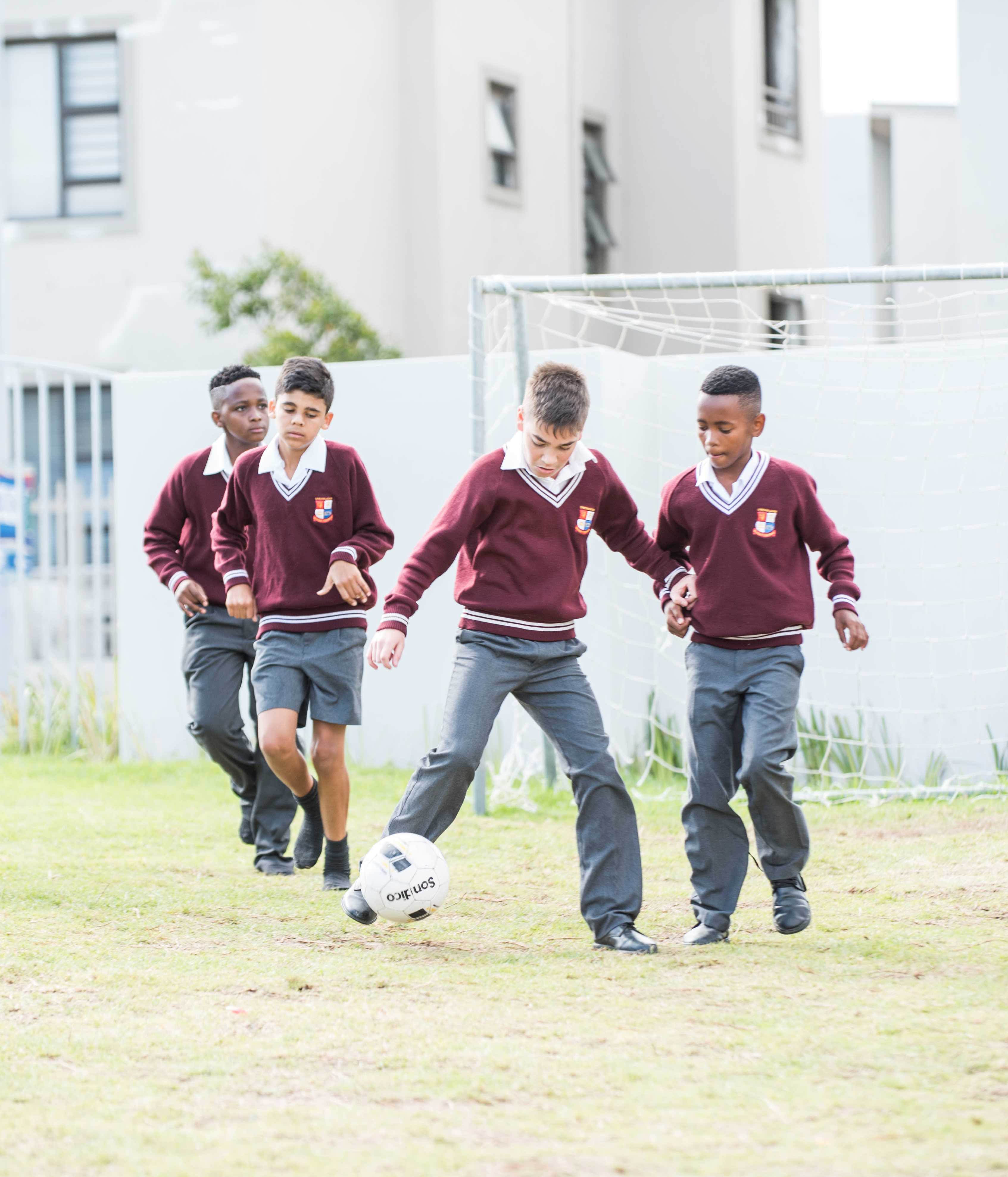 Riverside College High school learners playing soccer during break time
