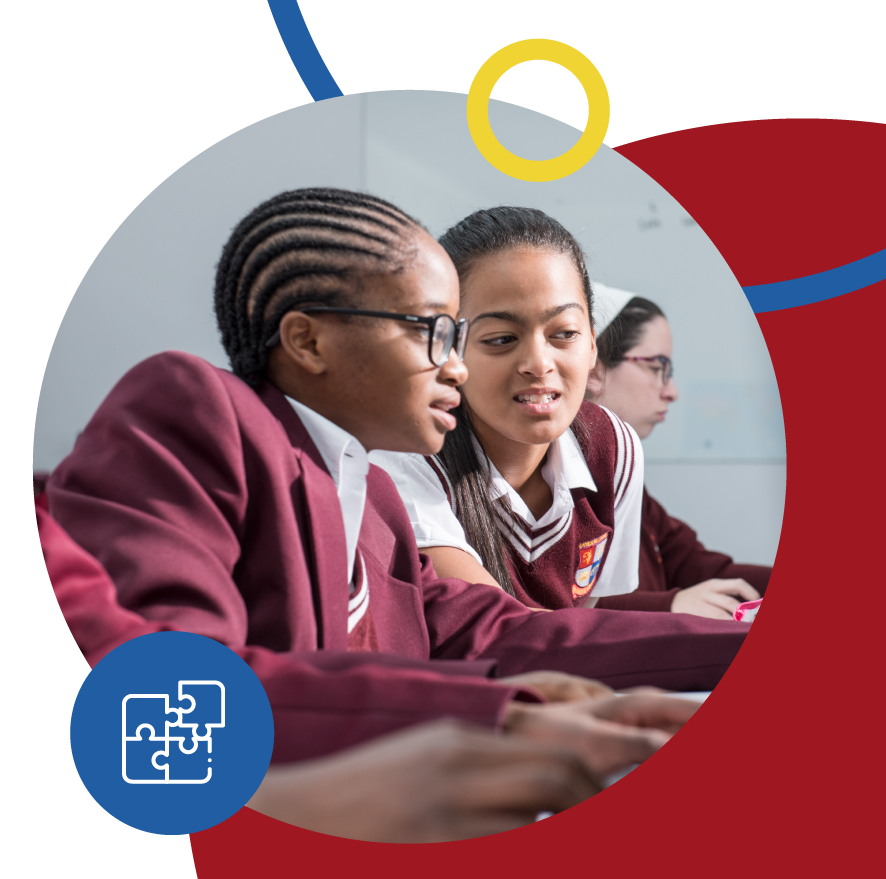 Three Riverside College High school learners in a classroom working on computers